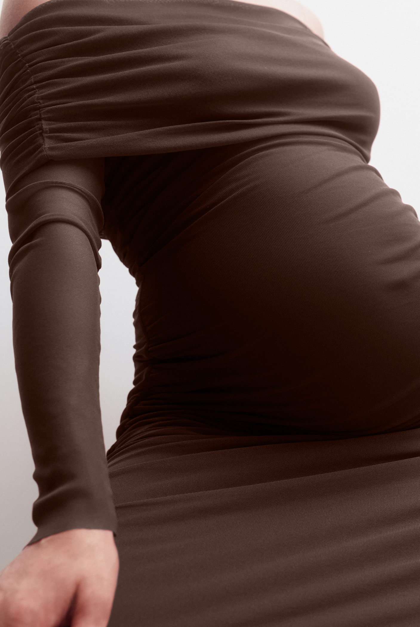 Brown dress with long sleeves on a plain background