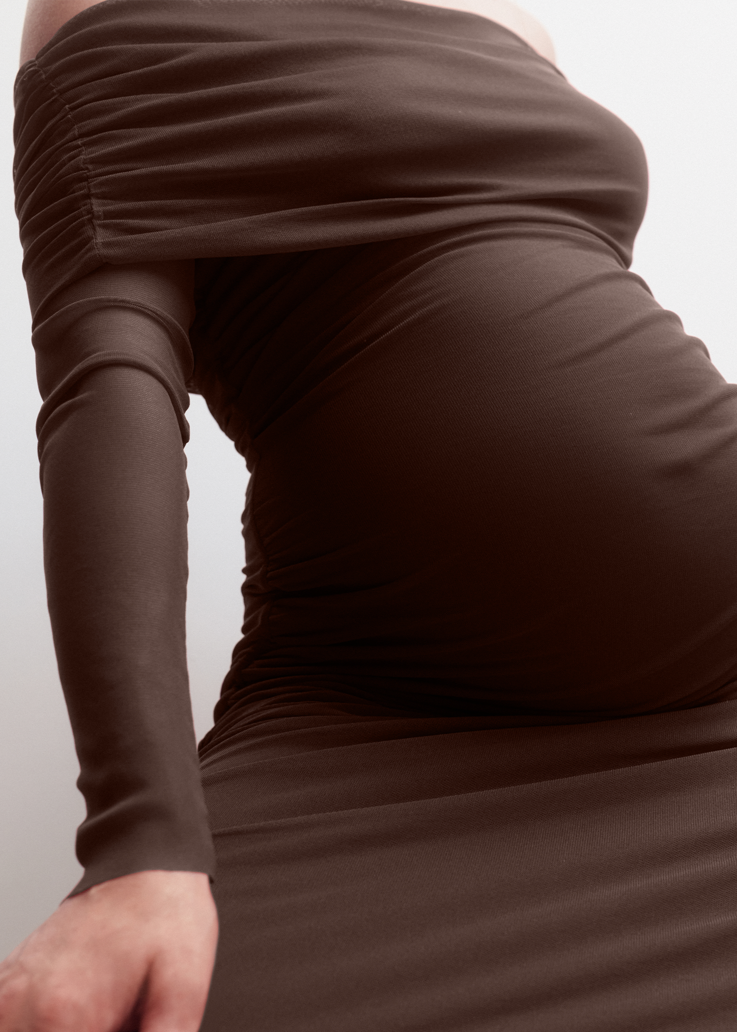 Brown dress with long sleeves on a plain background