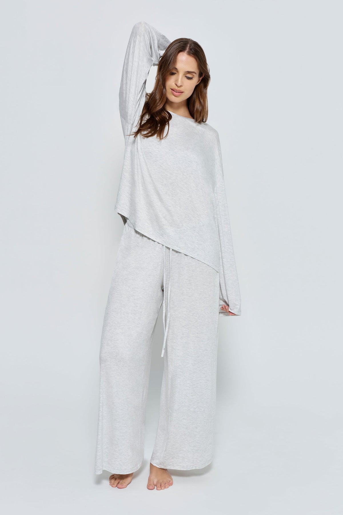 Front view of The Cloud Pant in ivory showcasing wide legs and adjustable drawstring waistband on a model with a light gray background