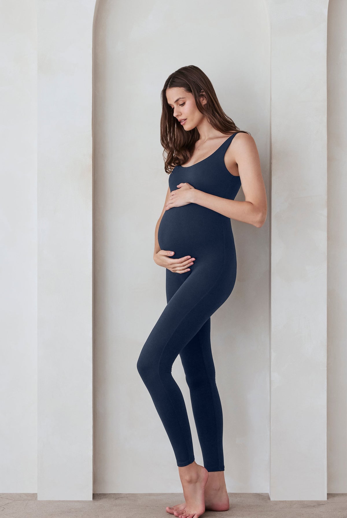 Pregnant woman in a navy jumpsuit by Bumpsuit
