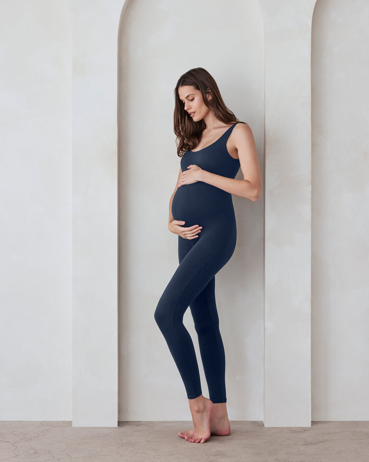 Pregnant woman wearing Bumpsuit Navy Lucy Jumpsuit