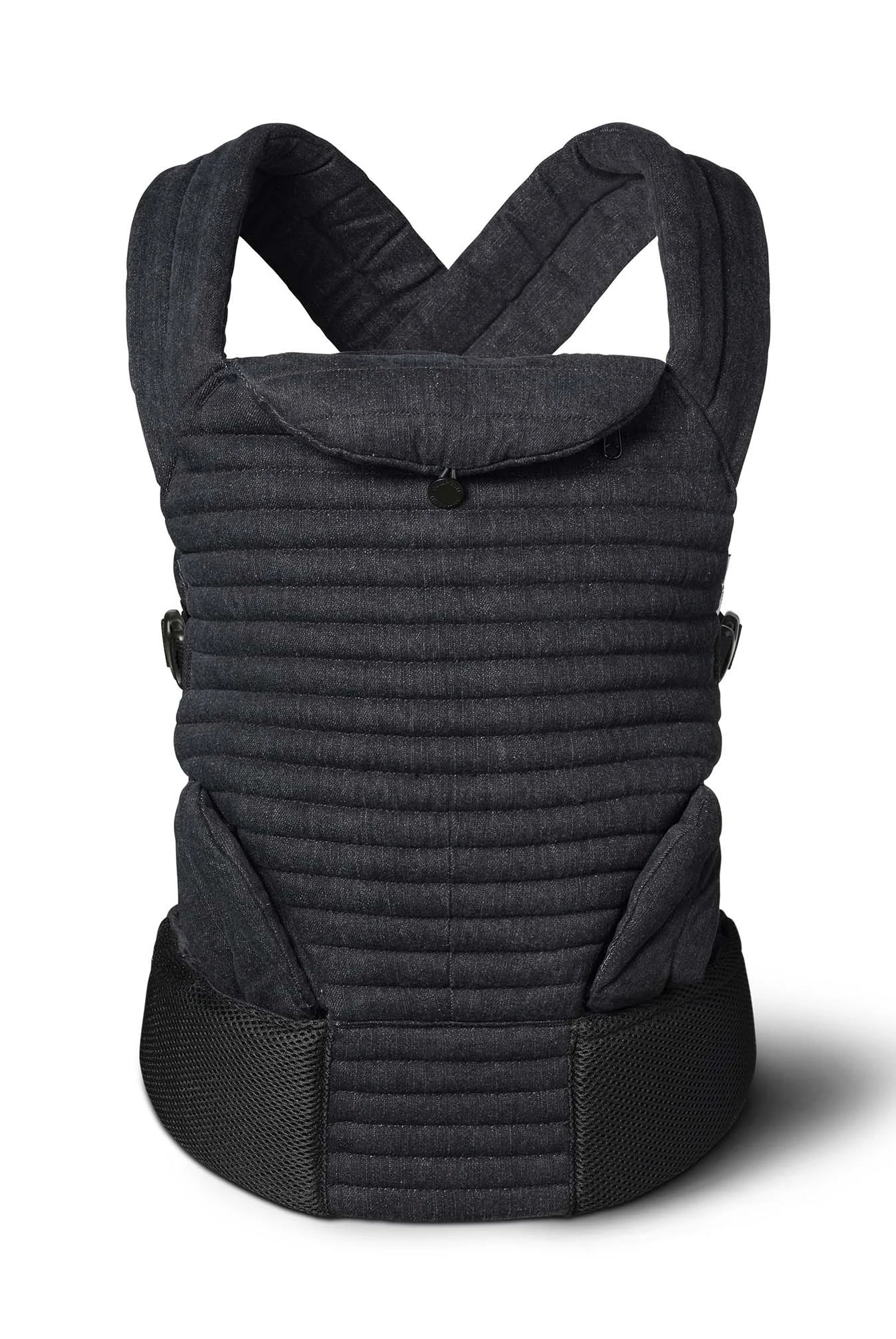 A Bumpsuit black denim quilted baby carrier with a textured fabric body, black mesh waist belt, and adjustable shoulder straps, with leg guards shown on a white background with a soft shadow.