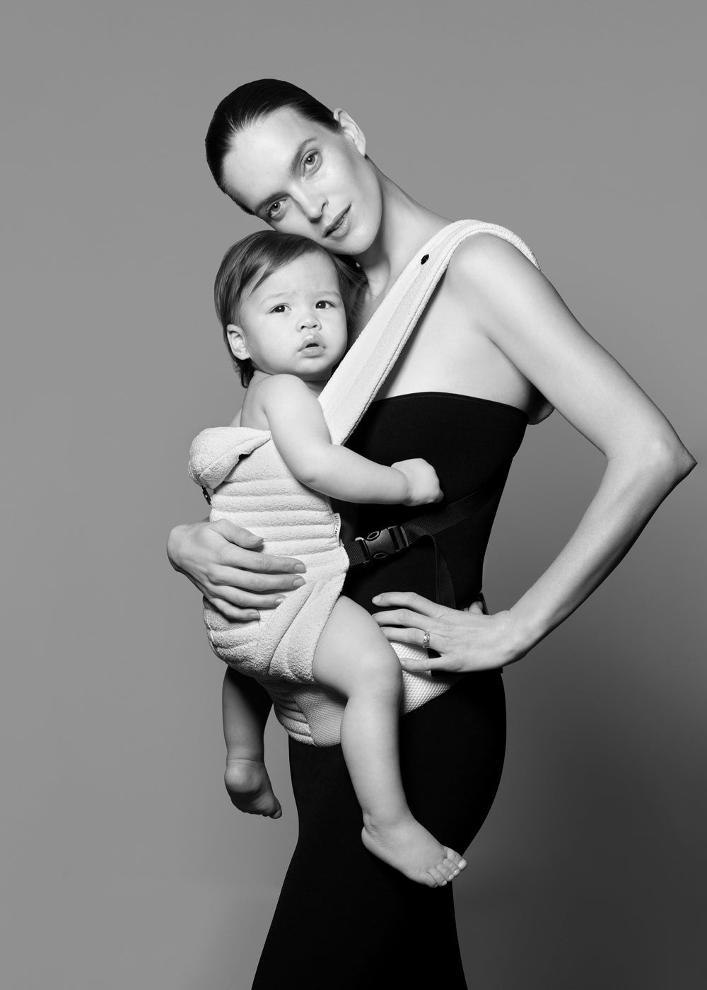 model with a baby in the bumpsuit baby carrier