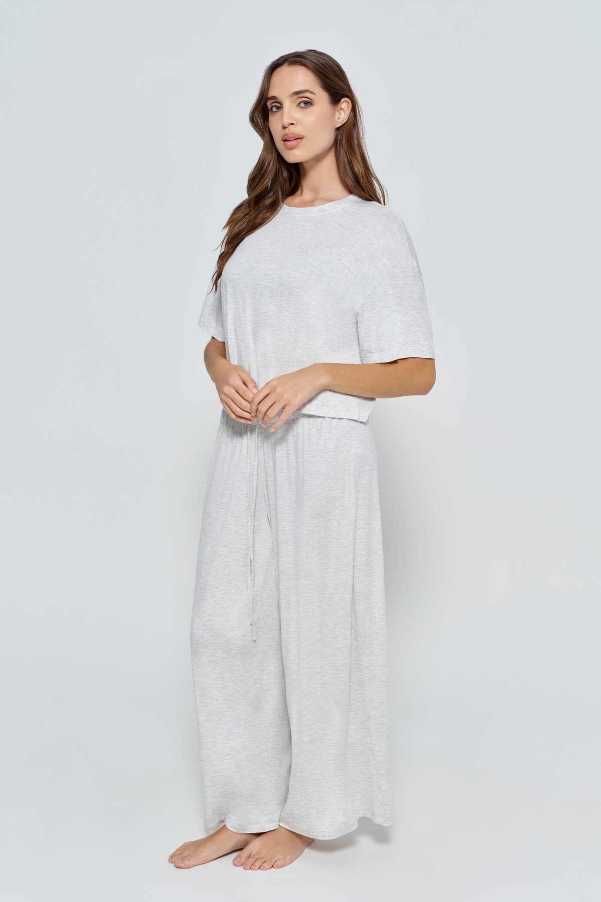 Pregnant woman wearing Bumpsuit Maternity Cloud Short Sleeve Crop Tee in heather grey