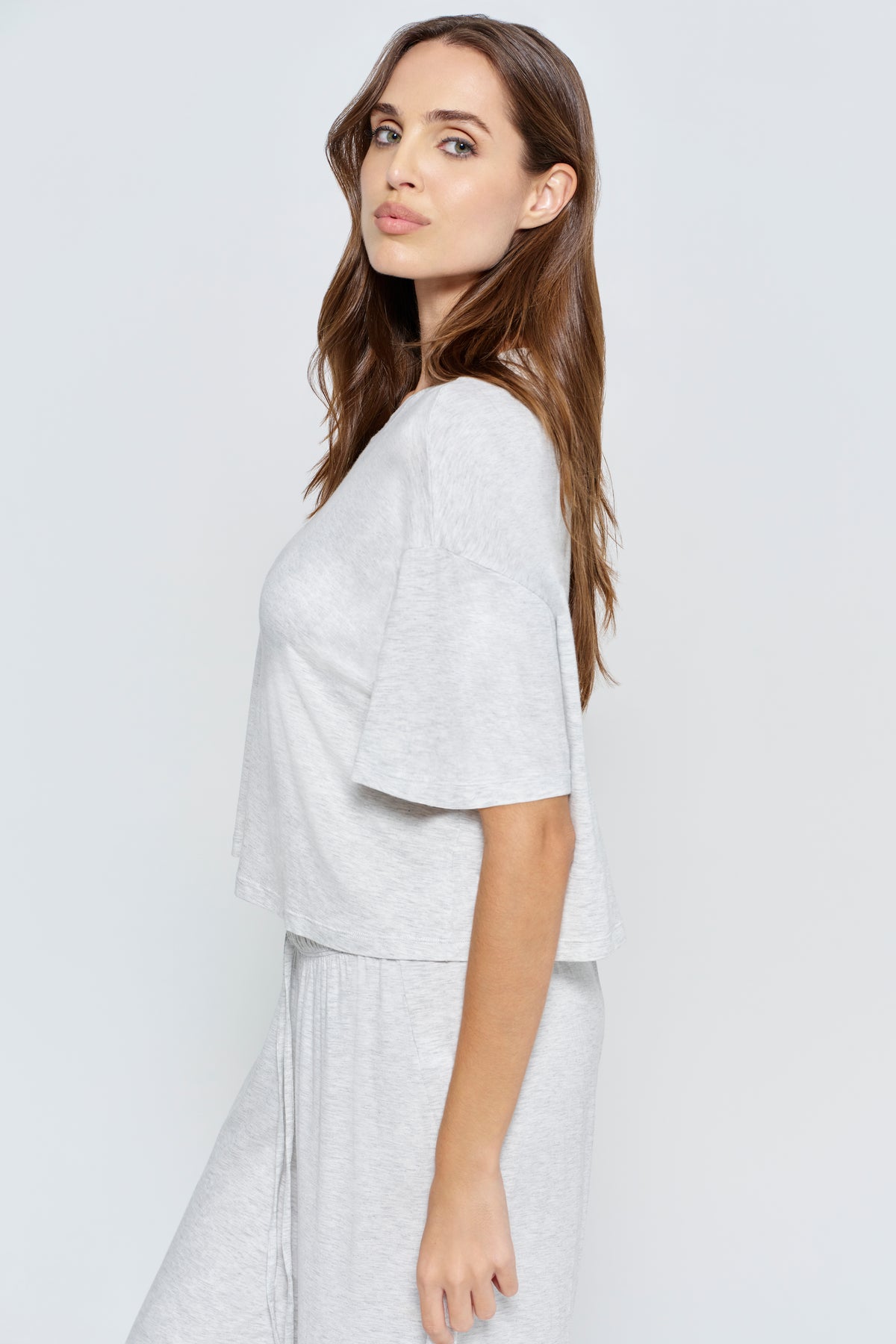 Pregnant woman wearing Bumpsuit Maternity Cloud Short Sleeve Crop Tee in heather grey