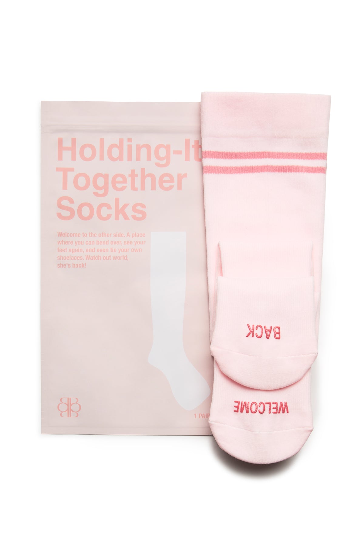 Close-up of ice pink compression socks showcasing pink stripes and a WELCOME BACK message with matching package