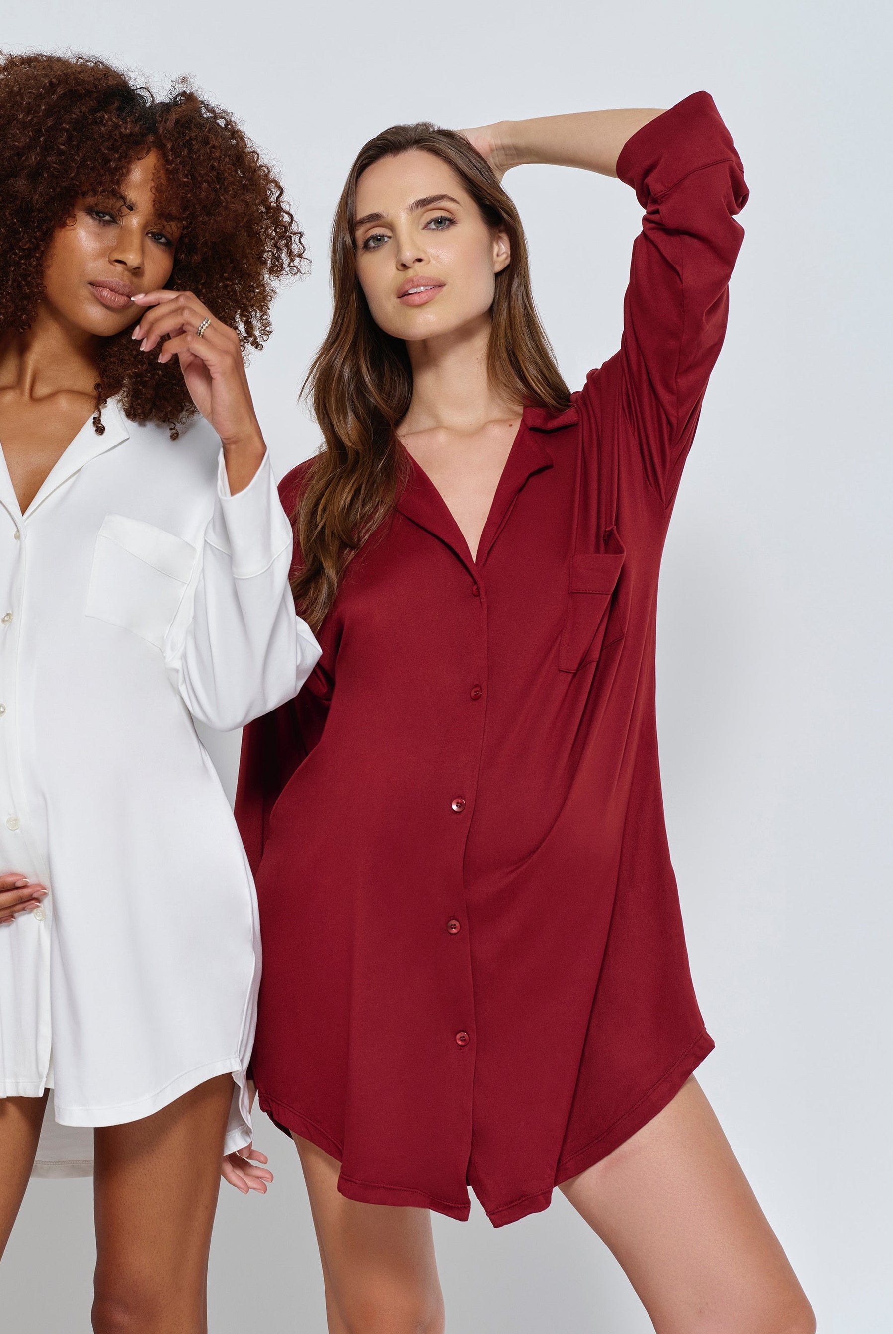 Two women wearing the Bumpsuit Cloud Pajama dress in ivory and burgundy against a white background