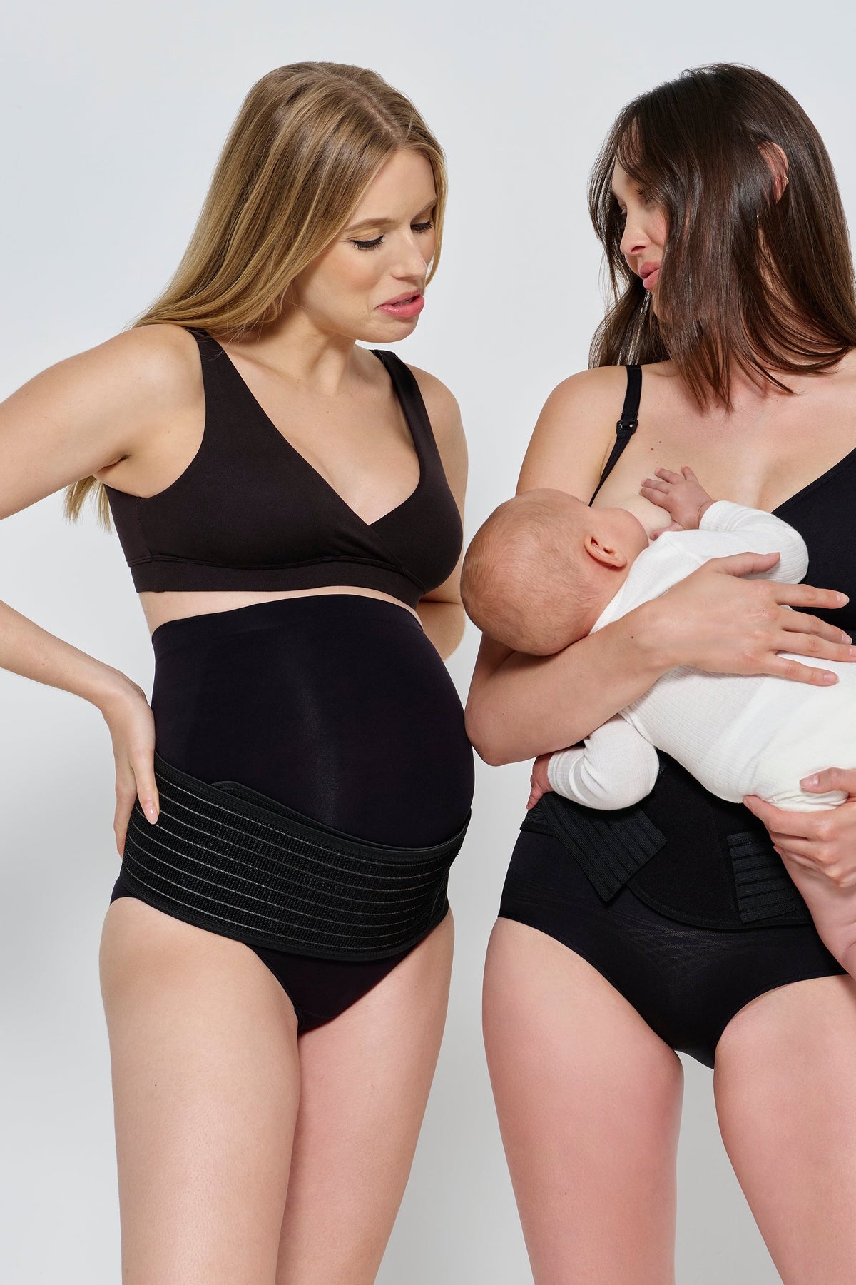 Front view of the black Reversible Comfy Nursing Bra showcasing pregnancy and breastfeeding use with a light studio background