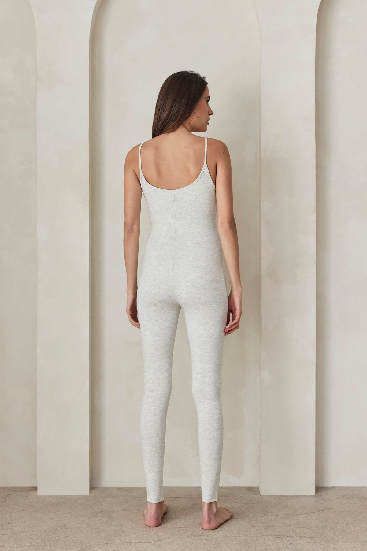 Back view of The Cotton Kate Unitard in heather grey showcasing its scoop back and thin straps against a white background