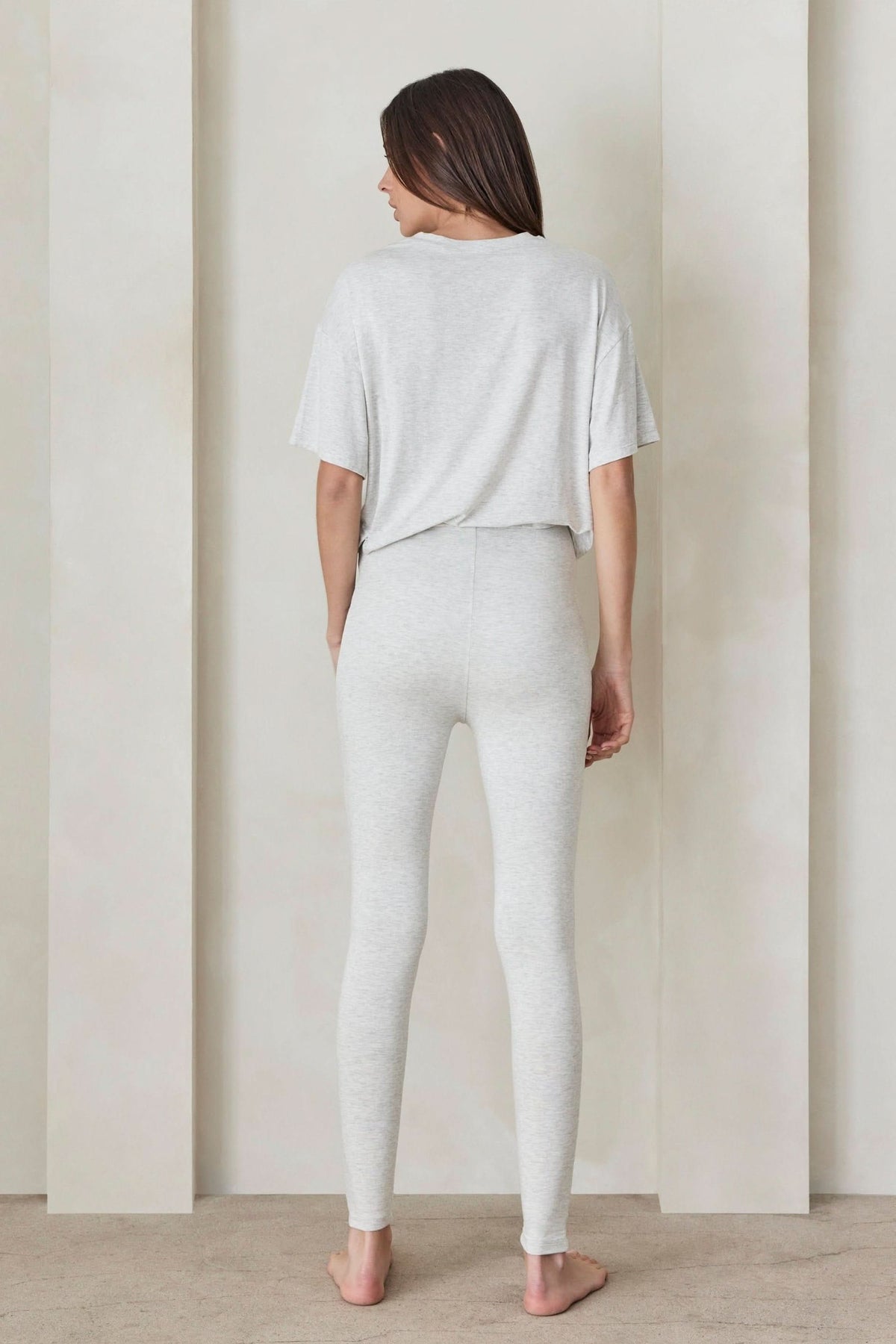 Pregnant woman wearing the Bumpsuit maternity the high rise full length legging in heather grey