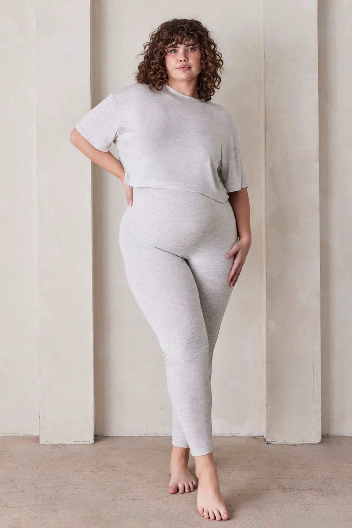 Pregnant woman wearing the Bumpsuit maternity the high rise full length legging in heather grey