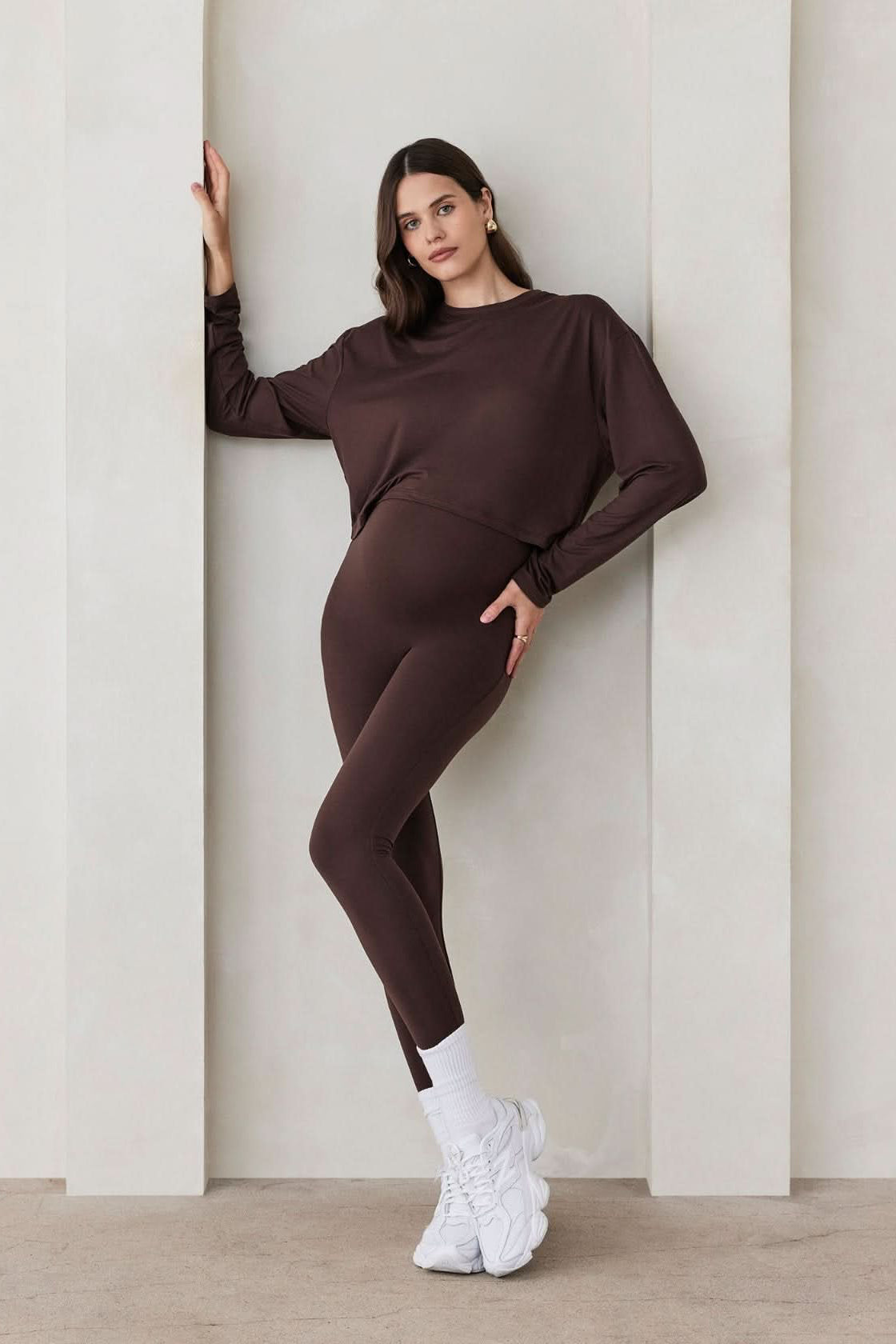 Pregnant woman wearing the Bumpsuit maternity the high rise full length legging in chocolate brown