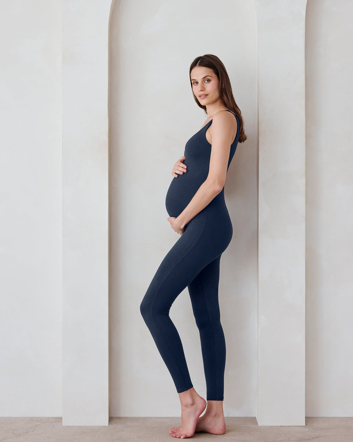 Pregnant woman in a navy jumpsuit by Bumpsuit