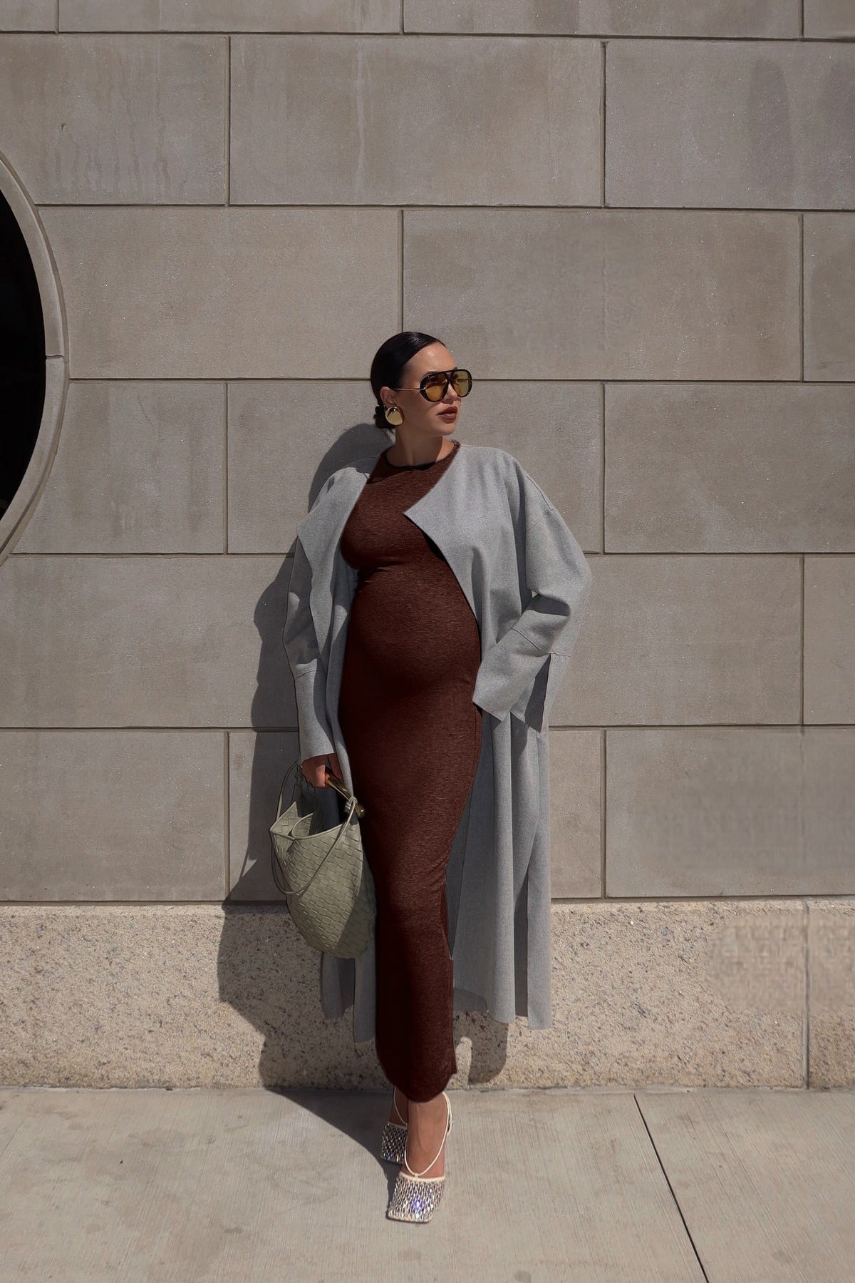 Full length view of Soft Rib Maxi Long Sleeve Dress in chocolate showcasing ribbed texture on a model against a tiled wall