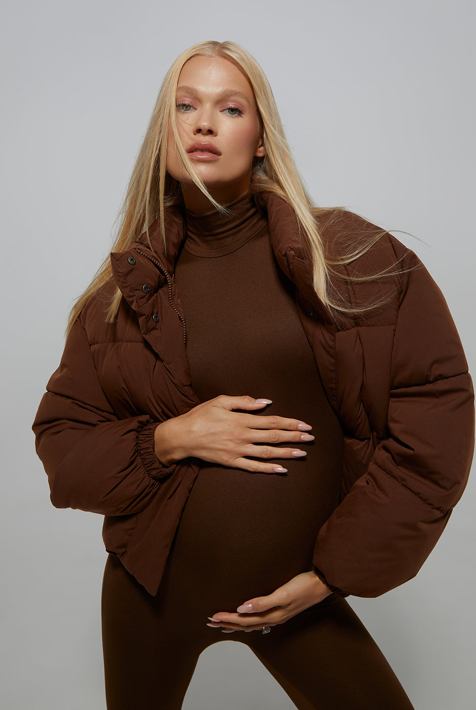 Bumpsuit Maternity Cropped Puffer Jacket in Chocolate worn by Vita Sidorkina