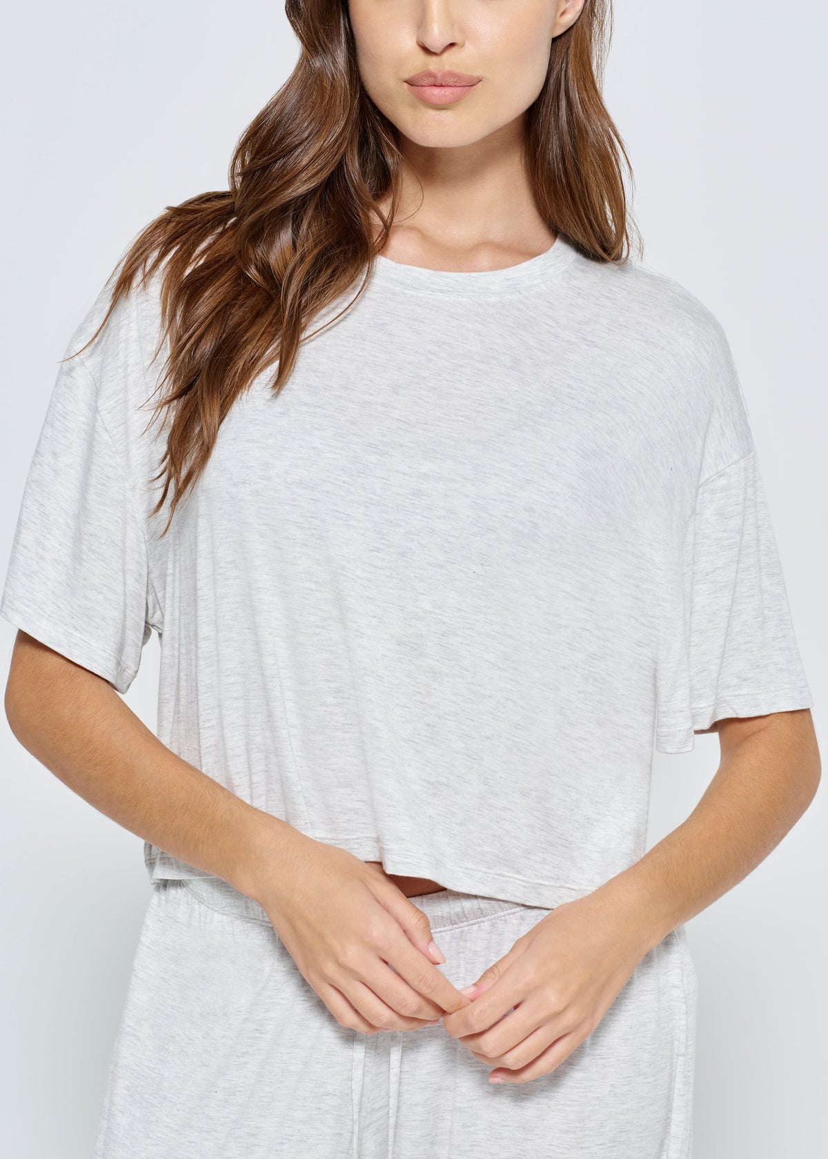 Pregnant woman wearing Bumpsuit Maternity Cloud Short Sleeve Crop Tee in heather grey