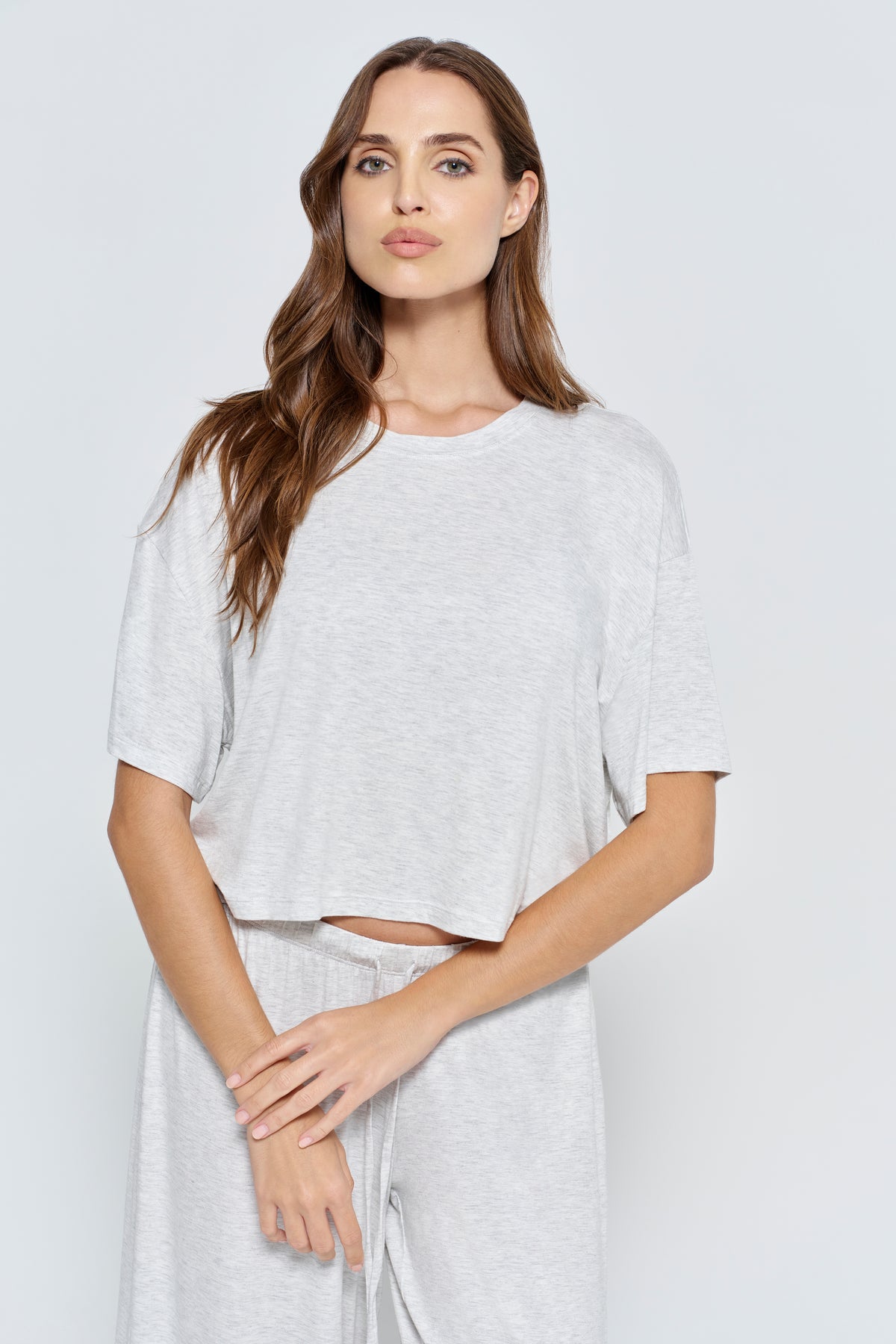 Pregnant woman wearing Bumpsuit Maternity Cloud Short Sleeve Crop Tee in heather grey