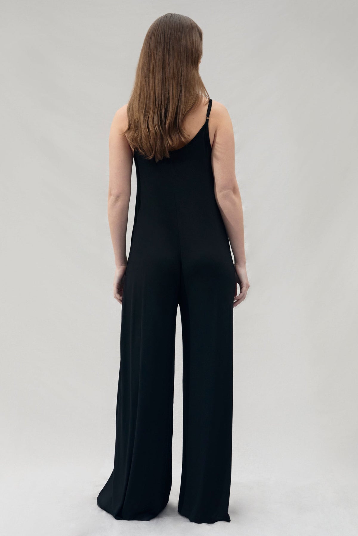 back view of pregnant woman wearing a Bumpsuit cotton black jumpsuit