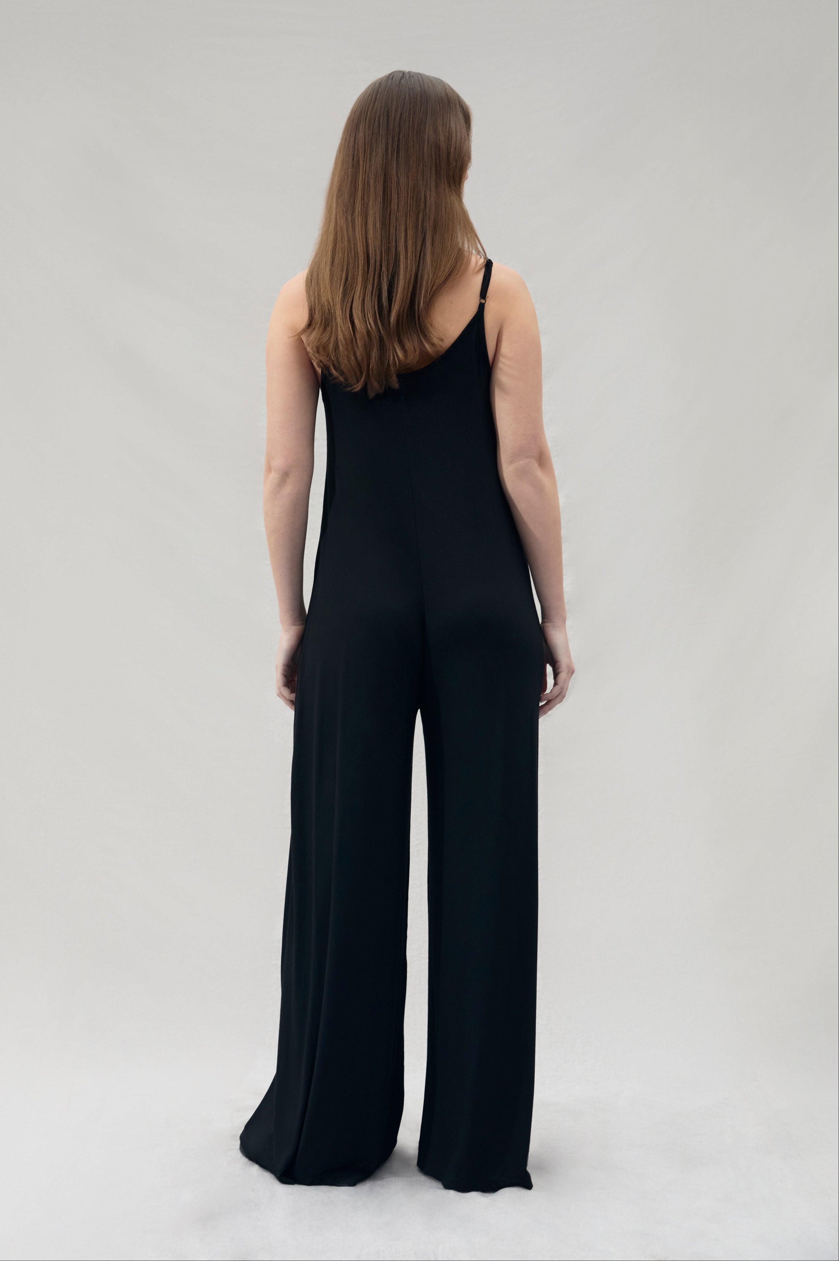 back view of pregnant woman wearing a Bumpsuit cotton black jumpsuit