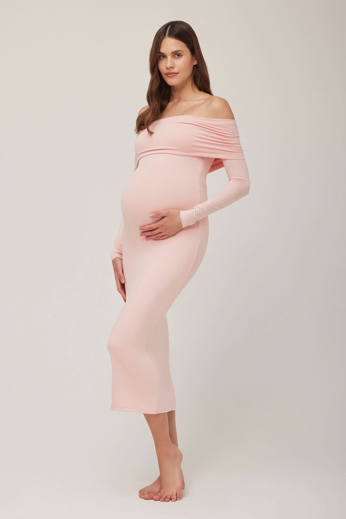 Pregnant woman wearing a dusty pink off-shoulder dress