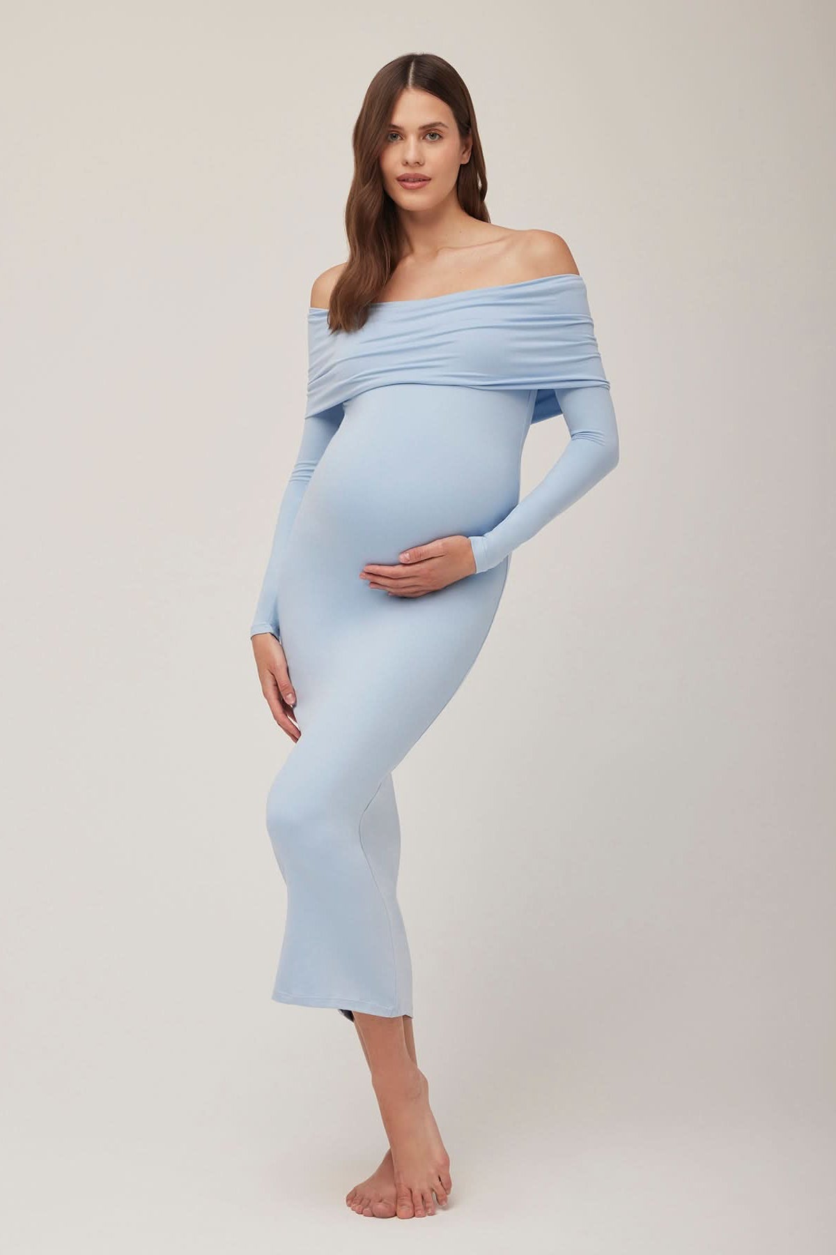 Pregnant woman wearing a powder blue off-shoulder dress