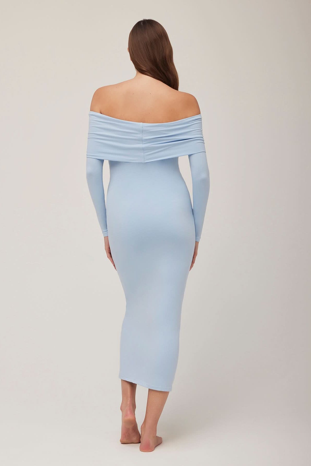 Pregnant woman wearing a powder blue off-shoulder dress