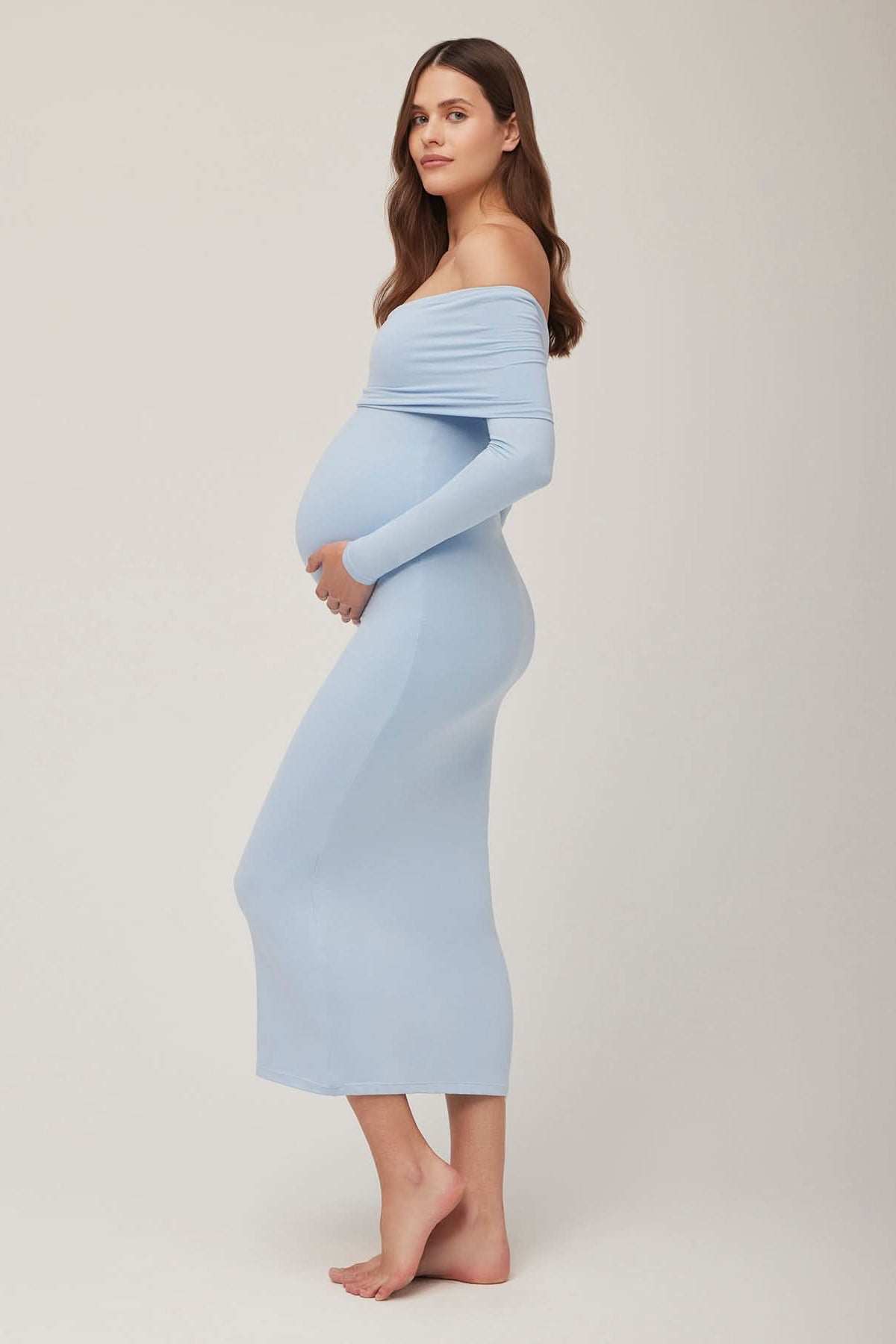 Pregnant woman wearing a powder blue off-shoulder dress