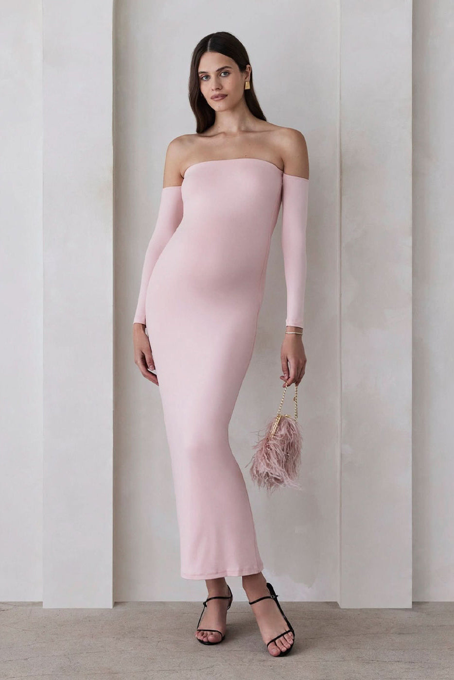 Front view of the Angelina maternity off-shoulder maxi dress in dusty pink with long sleeves on a model