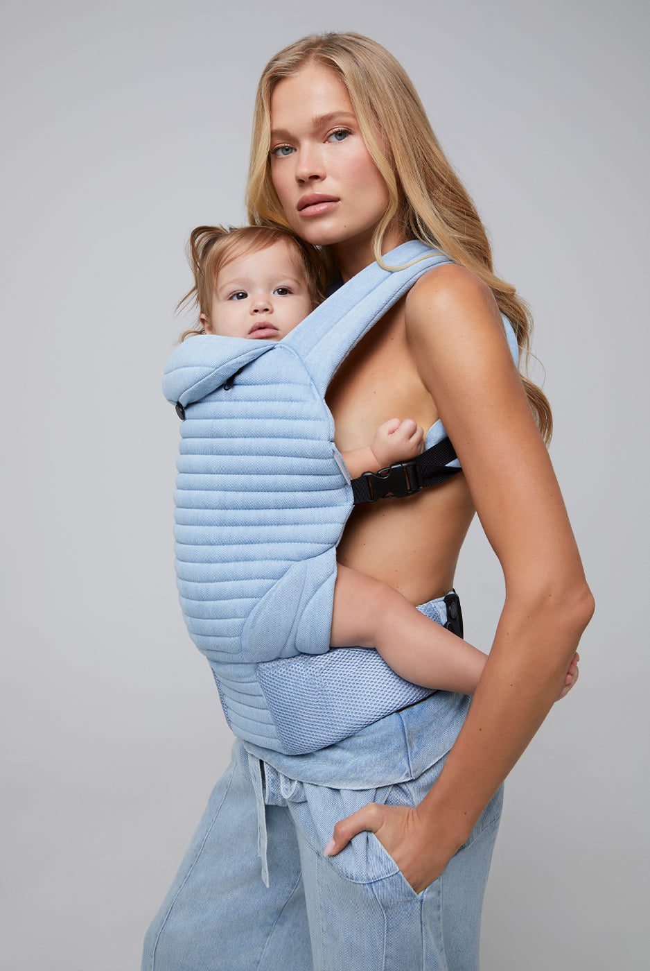 the armadillo baby carrier by bumpsuit in light denim