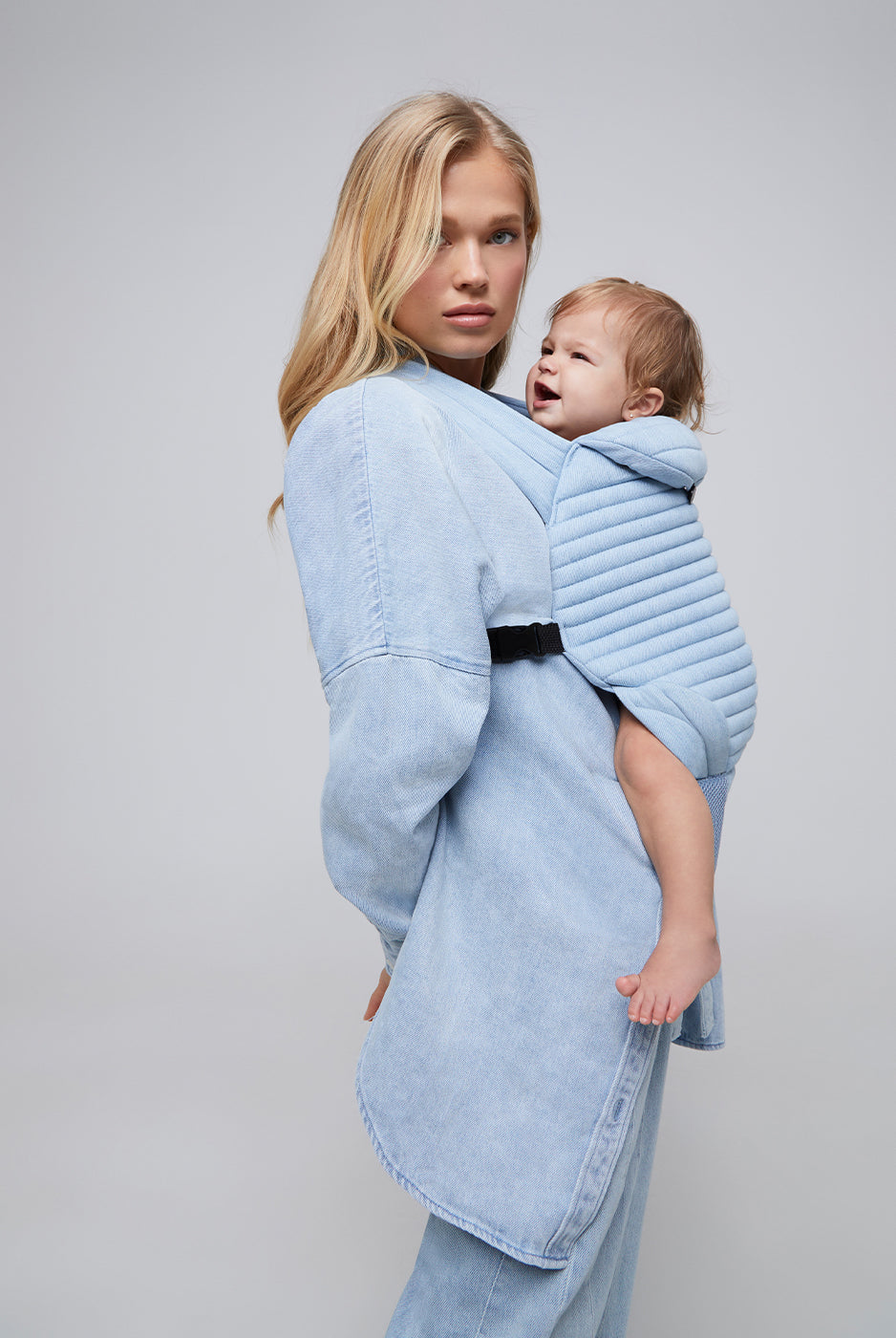 the armadillo baby carrier by bumpsuit in light denim