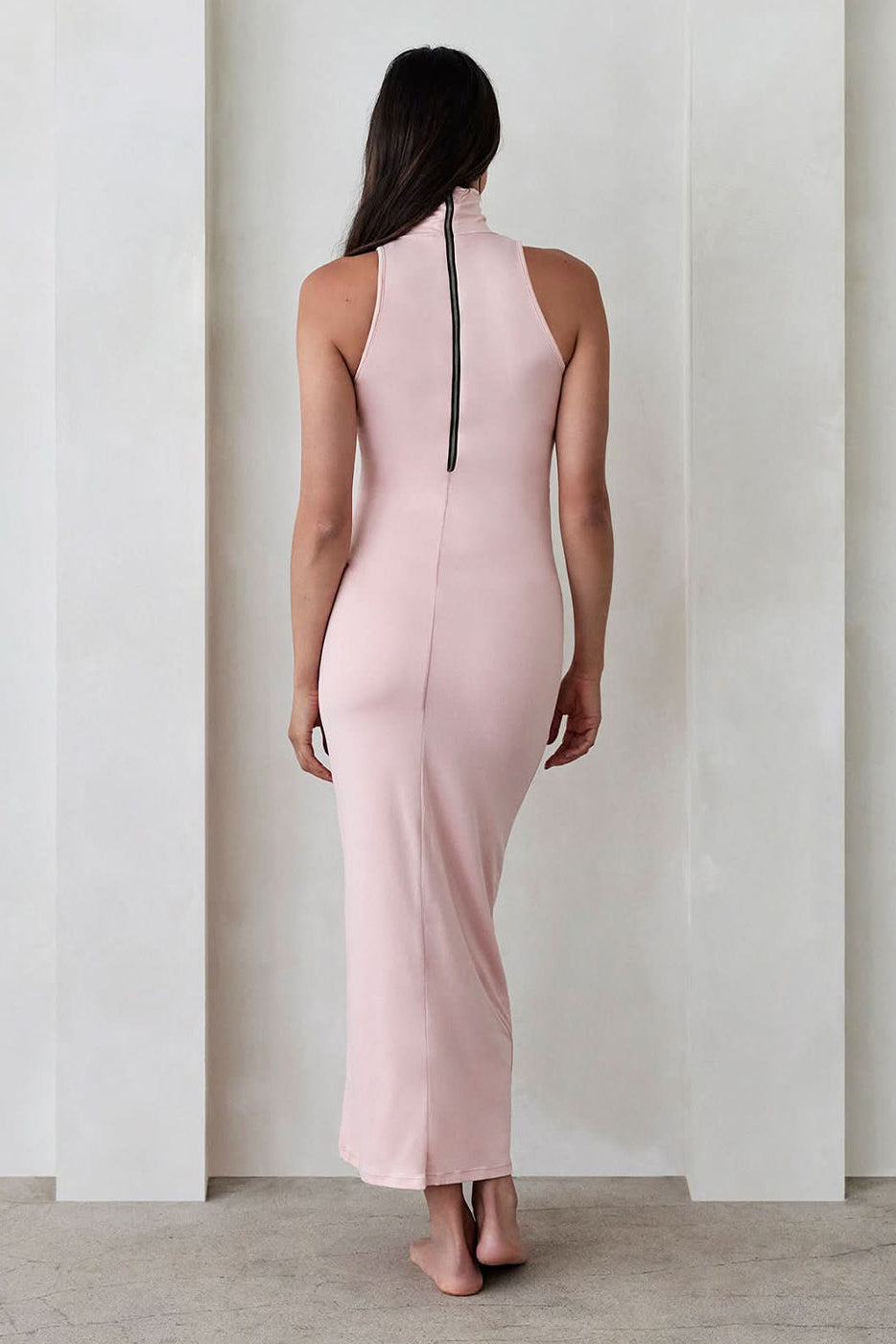back view of the serena turtleneck sleeveless maternity maxi dress in dusty pink