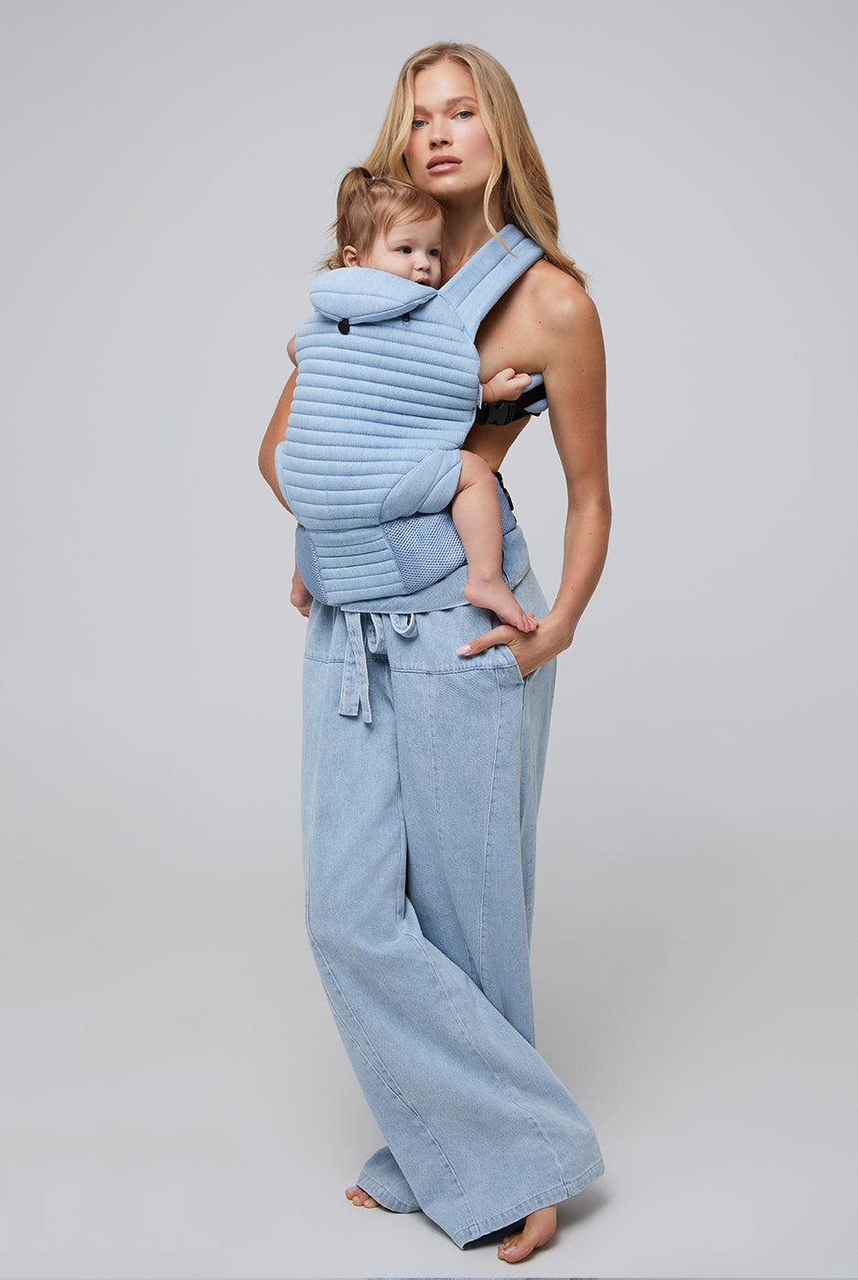 the armadillo baby carrier by bumpsuit in light denim