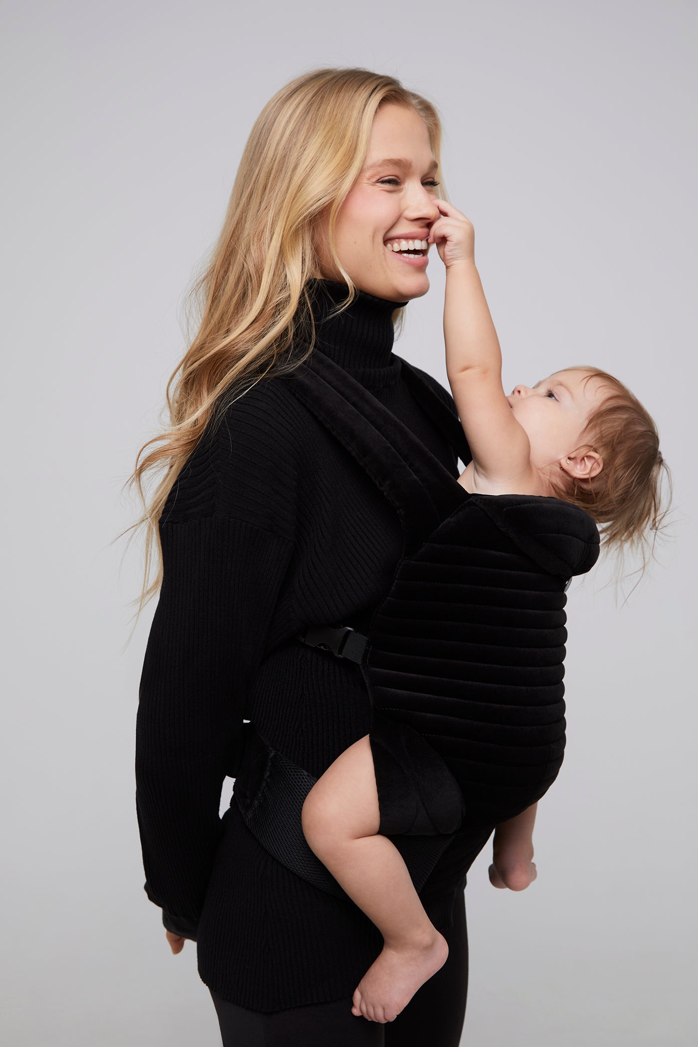model vita sidorkin with baby wearing the black velvet baby carrier