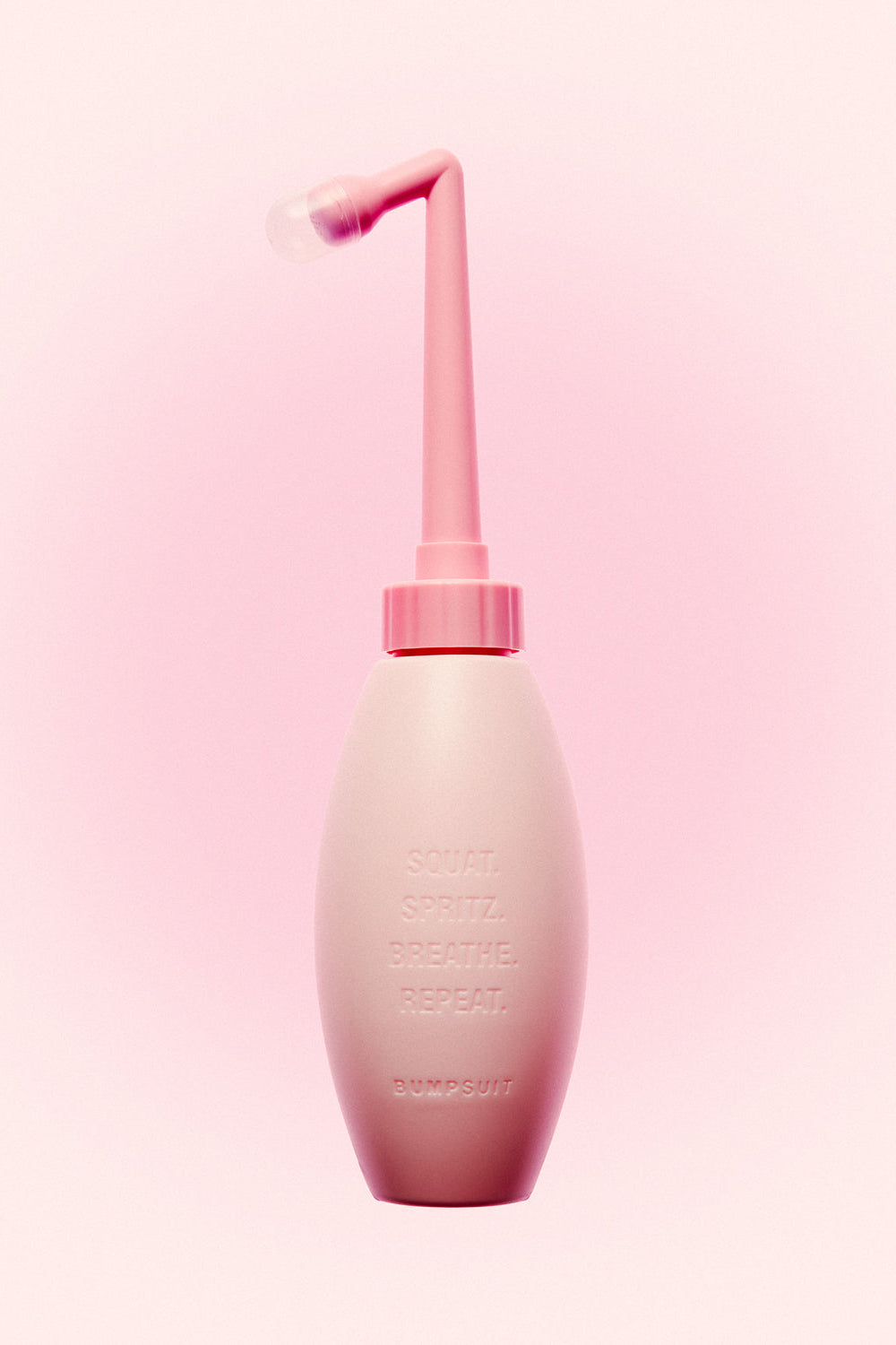 Front view of NO STING SPRITZ peri bottle showcasing its ergonomic angled spray spout against a pink background