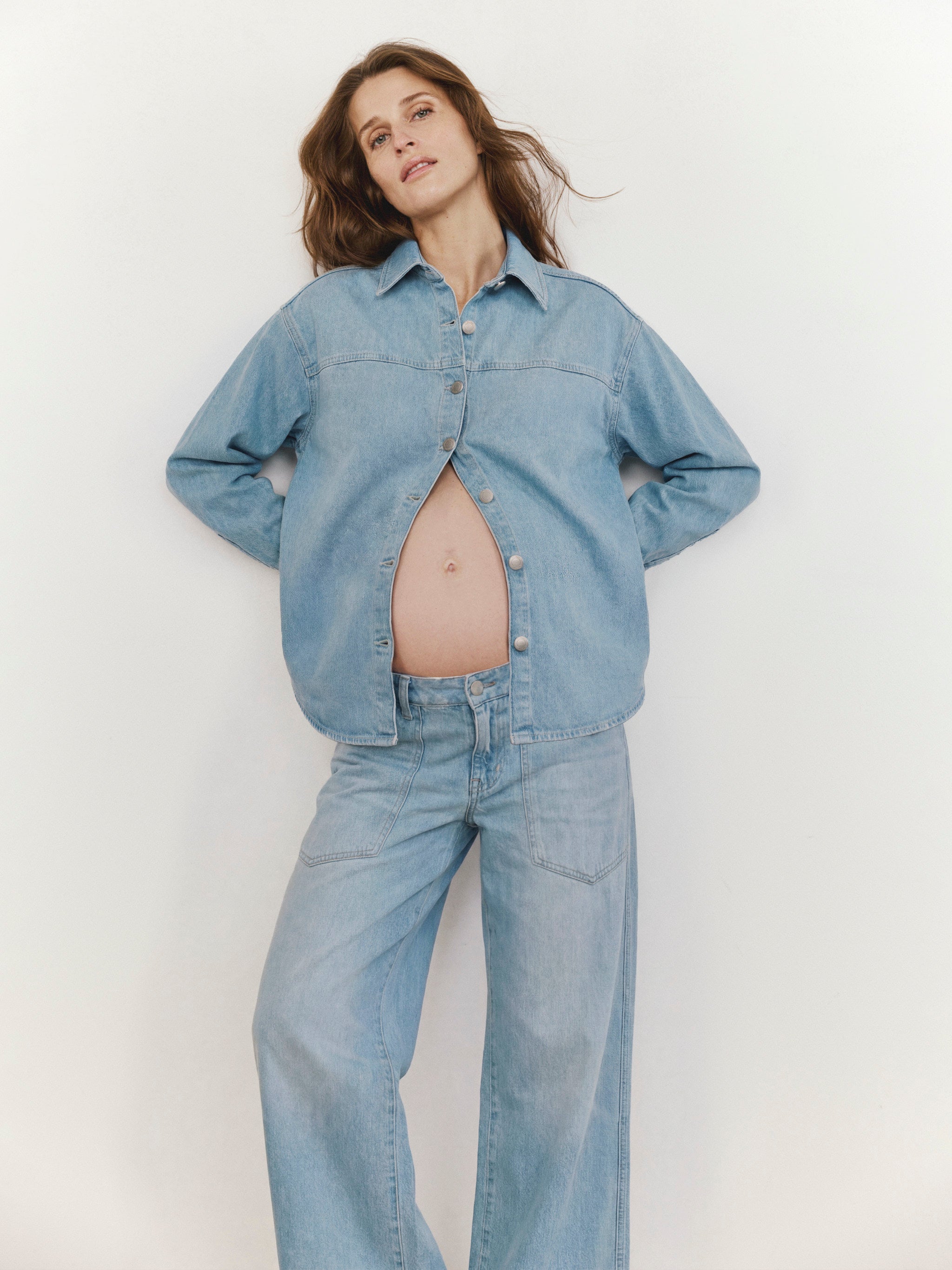 Woman wearing a denim outfit against a plain background