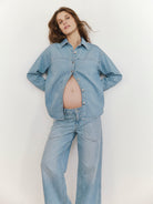 Woman wearing a denim outfit against a plain background