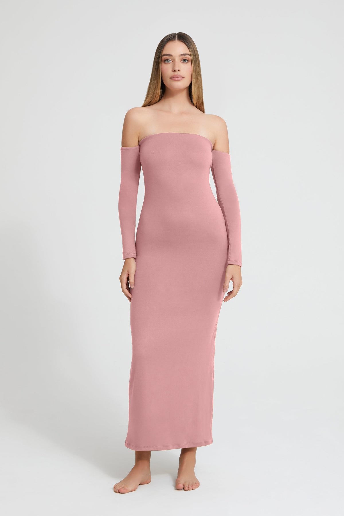 Front view of The Angelina Dress in mauve, showing its floor-length, body-hugging fit and off-the-shoulder sleeves on a model