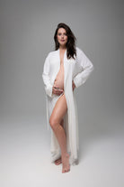 Woman wearing a white robe on a gray background