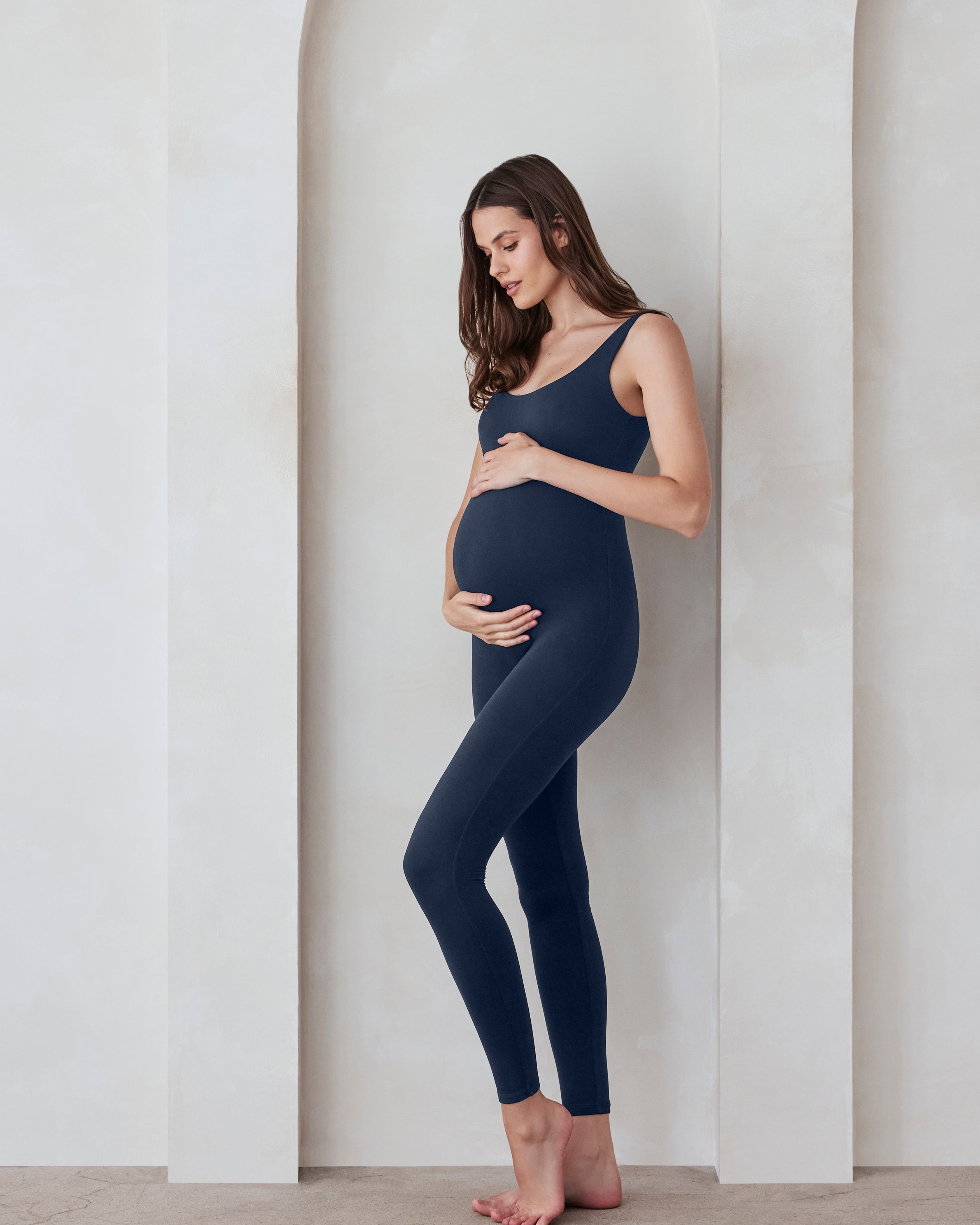 Pregnant woman in a navy jumpsuit by Bumpsuit