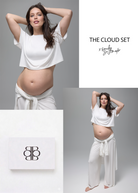 Emily Didonato wearing a white bumpsuit cloud lounge outfit, featuring a box with a logo.