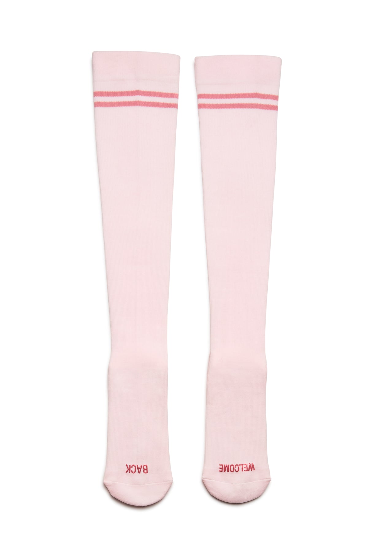 Top view of HOLDING IT TOGETHER compression socks with pink stripes and WELCOME BACK toe text on white