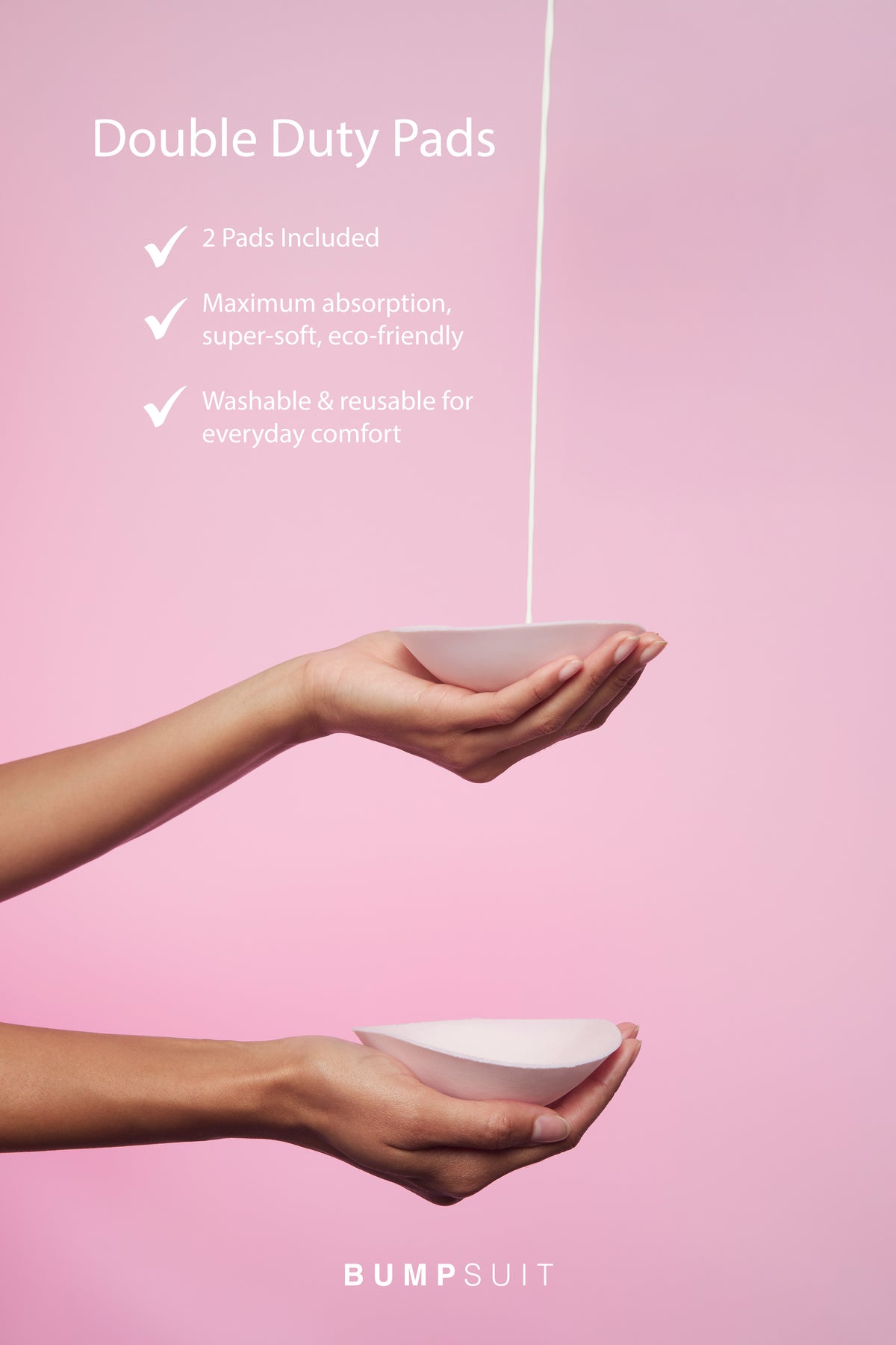 Close-up of Double Duty Pads nursing pad held in a hand, highlighting two pads, maximum absorption, and washable comfort on pink