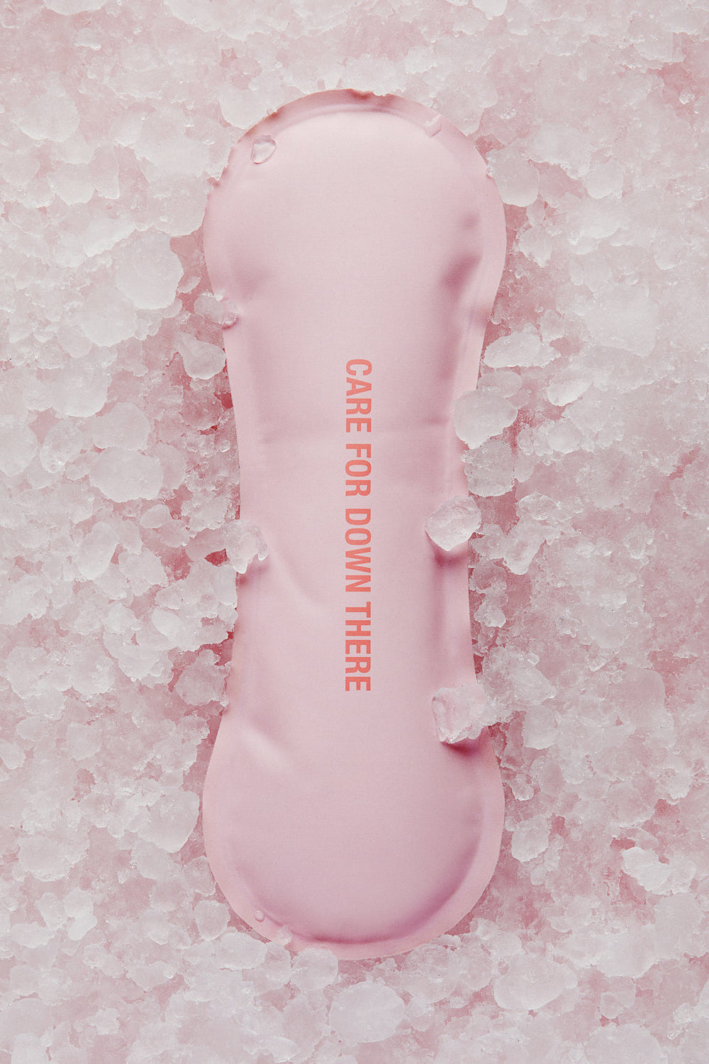 Top view of HOT-N-COLD BODY cooling and warming pack with CARE FOR DOWN THERE text on crushed ice