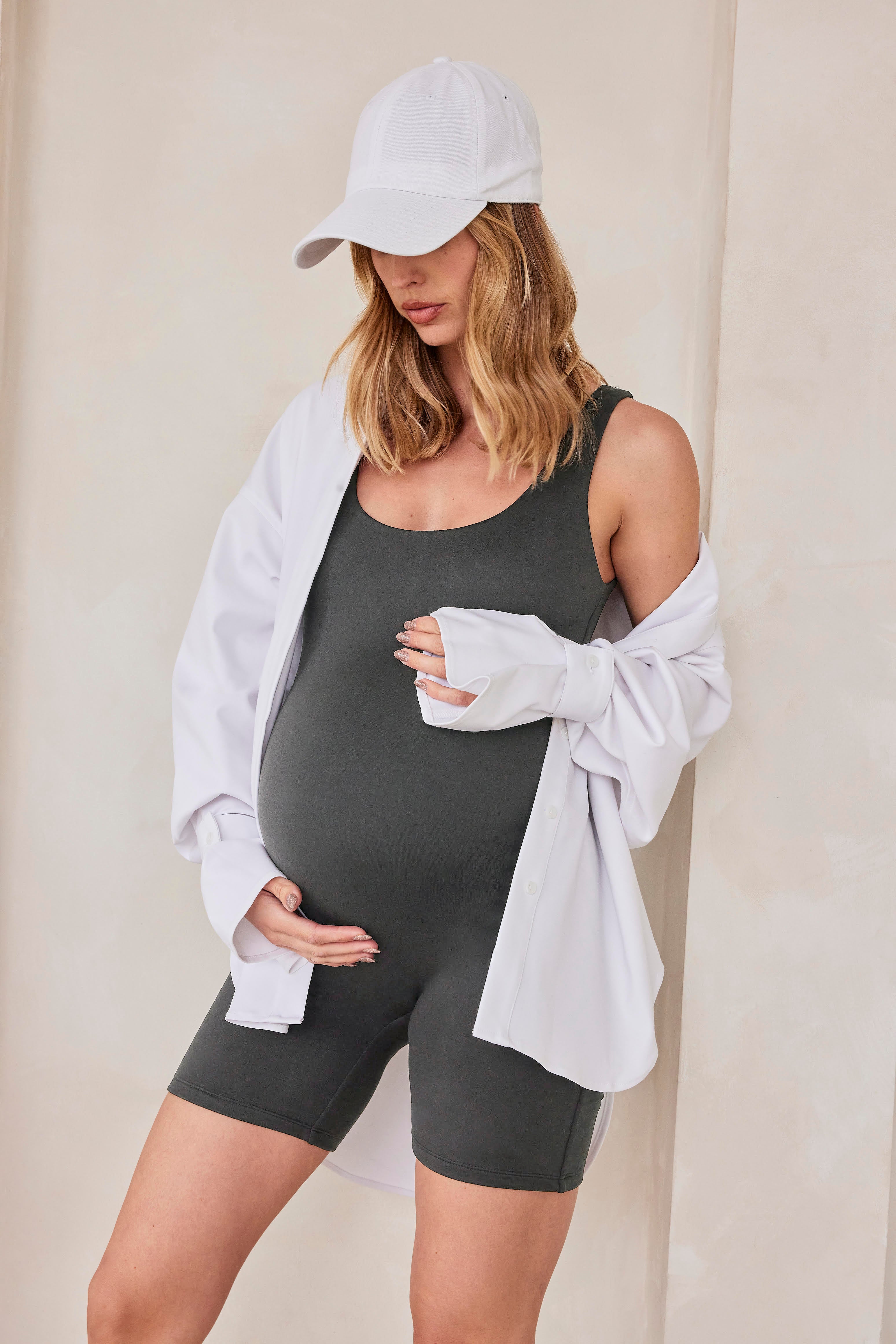 Pregnant woman wearing a slate grey bumpsuit