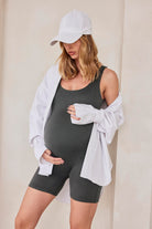 Pregnant woman wearing a slate grey bumpsuit