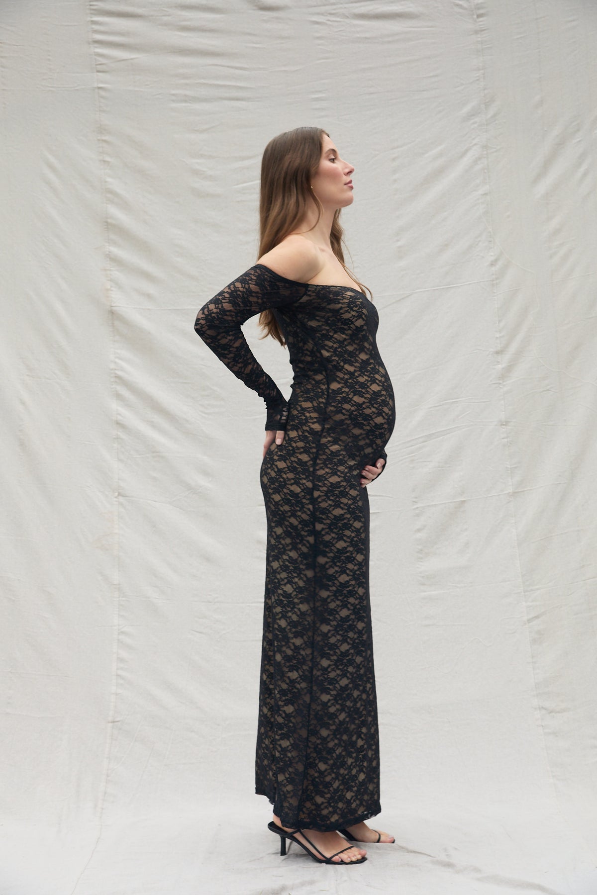 pregnant woman wearing a Bumpsuit off the shoulder lace dress