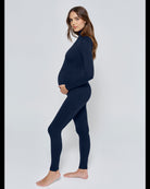 Pregnant woman wearing the Penelope Bumpsuit in Navy