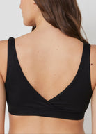 back view of a model wearing the reversible comfy bra in black
