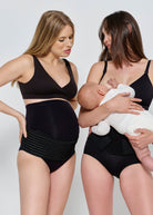 Two women wearing black maternity wear holding a baby.
