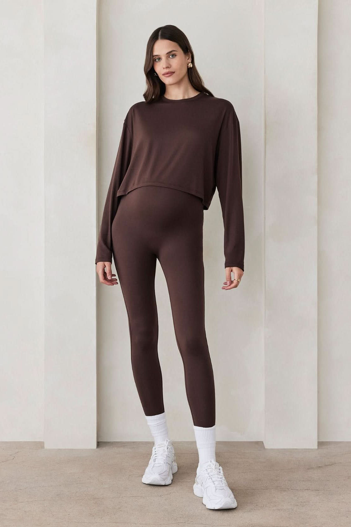Pregnant woman wearing the Bumpsuit maternity the high rise full length legging in chocolate brown